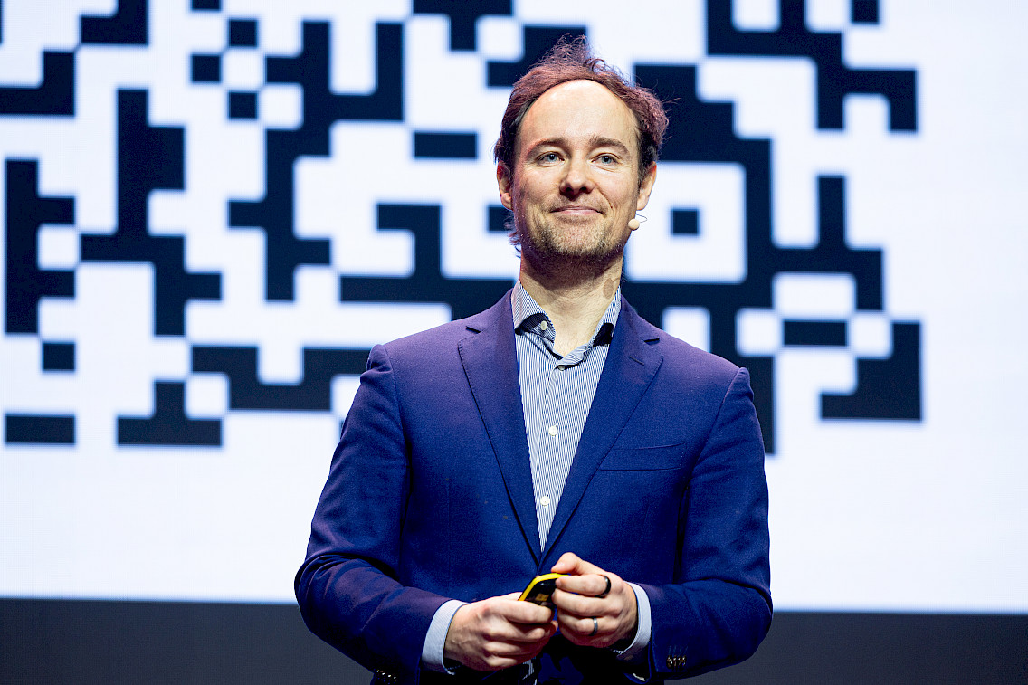 Martynas Kairys smiling, wearing a suit