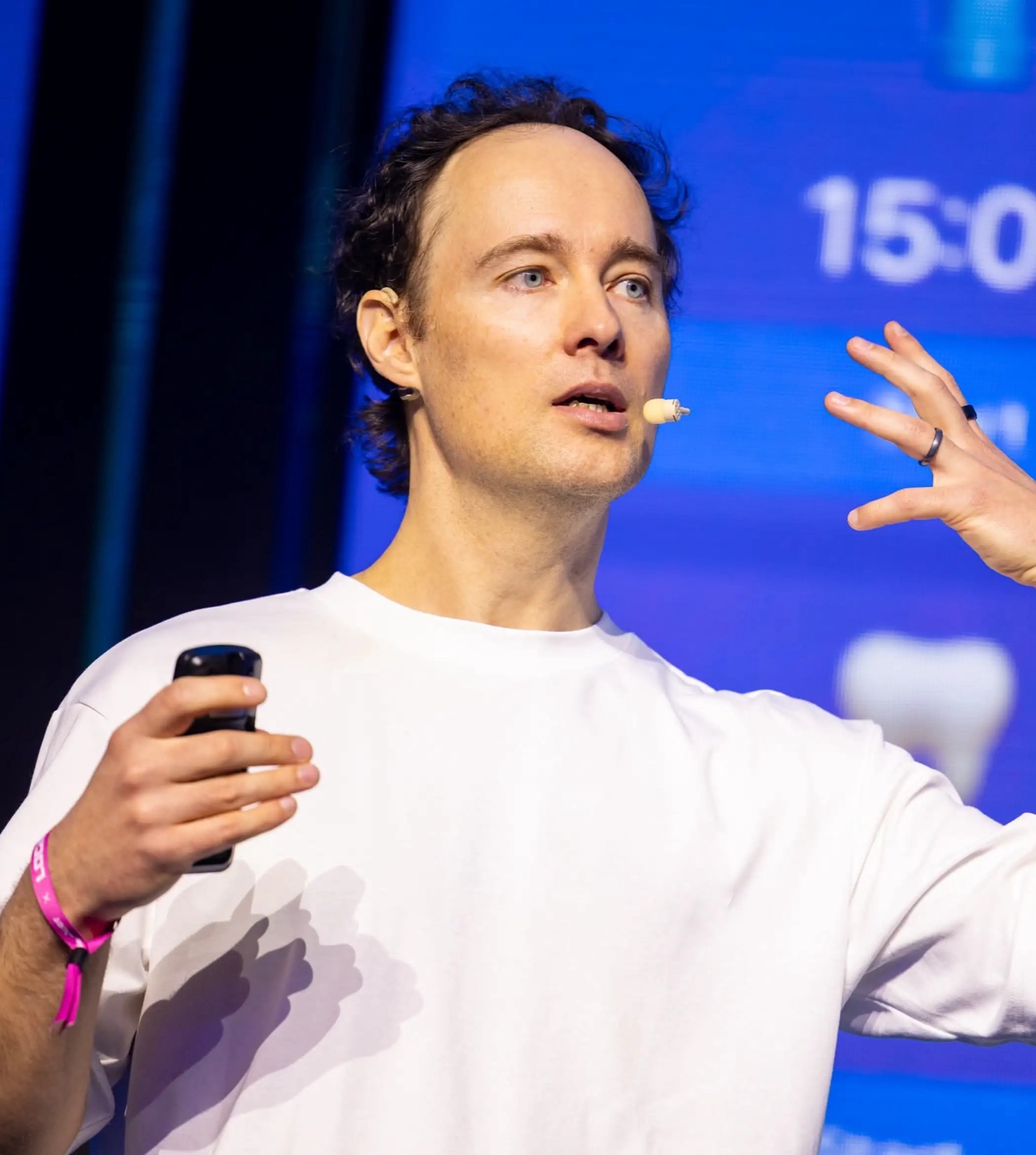 Martynas Kairys speaking on stage at a keynote event