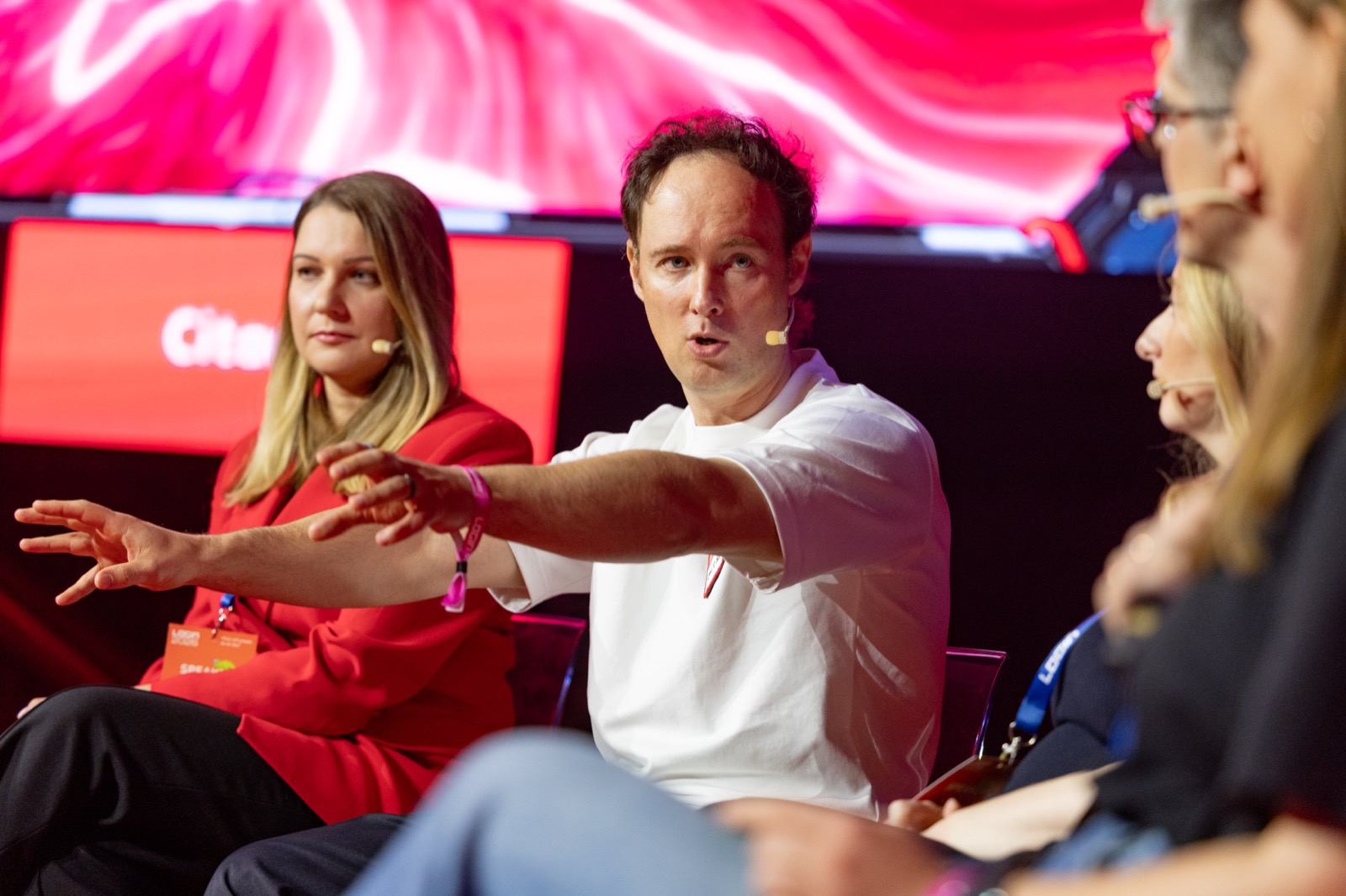 Martynas Kairys mid-answer on a LOGIN panel discussion, seated next to another speaker